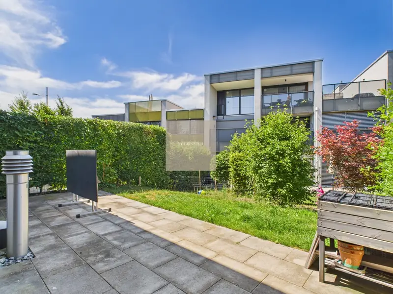 Paved seating area in front of the garden